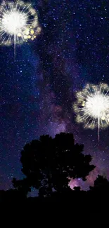 Starry night with fireworks and silhouettes in dark blue sky.