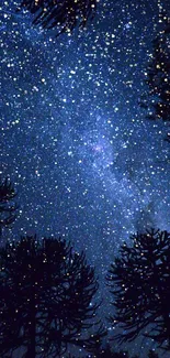 Starry night sky over forest silhouette with a cosmic view.