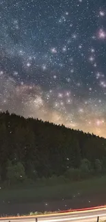 Forest under a starry night sky with cosmic view.