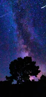 Galaxy and starry night sky wallpaper with silhouetted trees.