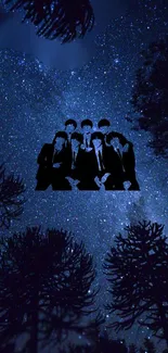 Silhouette of a group under a starry night sky surrounded by trees.