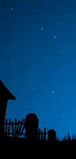 Starry night with church silhouette under a midnight blue sky.