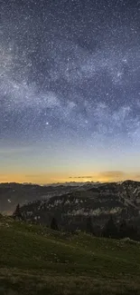 Starry night sky over mountain landscape with distant horizon.