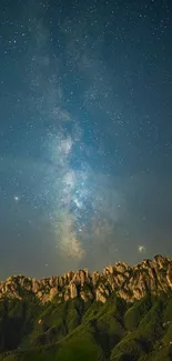 Starry night sky over rugged mountain landscape.