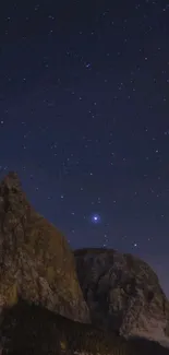 Starry night sky over mountain landscape.