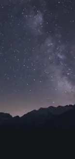 Starry night sky over mountain range wallpaper with galaxy view.