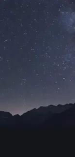 Starry night over mountains with clear sky.