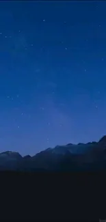 Serene starry night over dark mountains.
