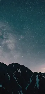 Starry night sky over dark mountainous silhouette.