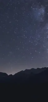 Starry night sky over mountain silhouettes, creating a serene and peaceful backdrop.