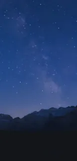 Starry night sky over mountains scenery wallpaper.