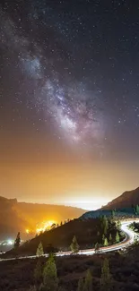 Starry night over a winding mountain road under the Milky Way sky.