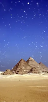 Giza pyramids under a starry night sky with a desert landscape.