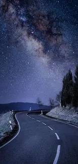 Starry night sky over a winding road with Milky Way.