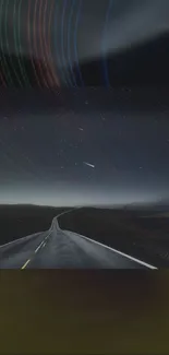 A road leading into a dark starry night with trails across the sky.