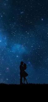 Silhouette of a couple under a starry night sky with a lone tree.