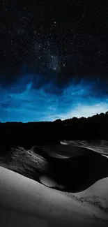 Starry sky over serene sand dunes at night.