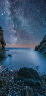 Starry night sky over a calm sea between rocky cliffs.