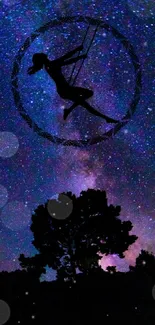 Silhouette of a person swinging under a starry night sky.