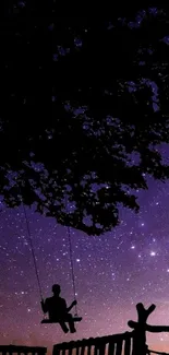 Silhouette of a child on a swing under a starry purple sky.