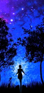 Silhouette under a starry royal blue night sky with trees.