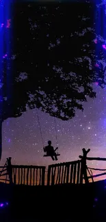 Silhouette of tree and swing under a starry night sky.