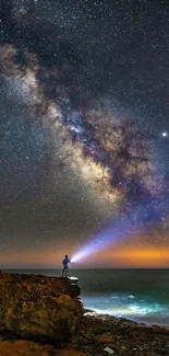 A lone adventurer beneath a starry night sky over the ocean, featuring the Milky Way.