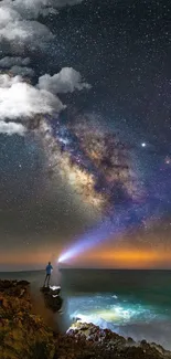 Starry night sky with Milky Way and figure with flashlight.