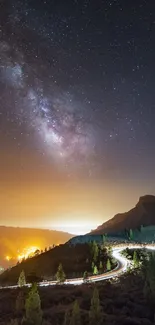 Starry night sky over a mountain road with a glowing horizon.