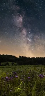 Starry night sky over meadow with purple flowers and distant trees.