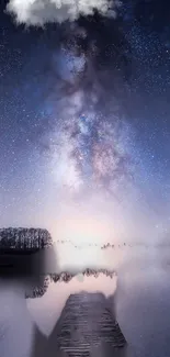 Starry night sky reflected over calm, misty waters with trees in the background.