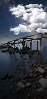 Starry sky and clouds over a wooden dock.