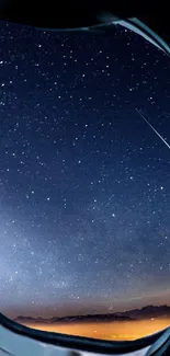 View of a starry night sky through an airplane window.