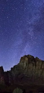 Starry night sky mobile wallpaper with a mountain silhouette.