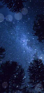 Starry night sky with silhouetted trees and sparkling stars.