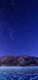 Starry night sky over a salt flat landscape.