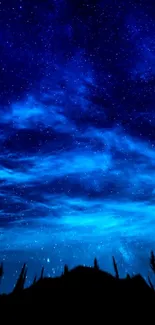 Deep blue starry night sky wallpaper with wispy clouds.