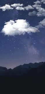 Starry night sky above mountains with clouds.