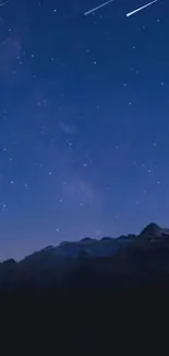 Starry night sky over mountain landscape wallpaper.