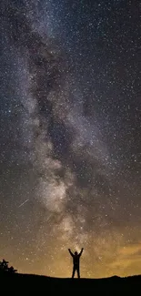 Silhouette under starry night sky showcasing the Milky Way.