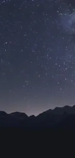 Starry night sky over mountains wallpaper.