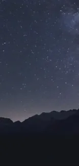 Starry night sky over mountains wallpaper.