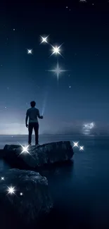 Man standing on rocks gazing at a starry night sky, surrounded by shimmering stars.