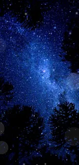 Starry night sky with silhouetted trees, perfect for mobile wallpaper.