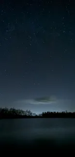 Starry night sky above a tranquil lake landscape.