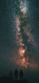 Silhouette beneath starry night sky with Milky Way.