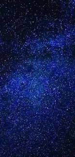 Starry night sky wallpaper with deep blue galaxy and twinkling stars.