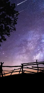 Starry night sky wallpaper with silhouette of swing.