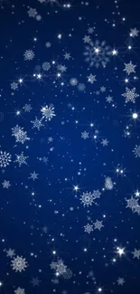 Starry night sky with snowflakes on blue backdrop.