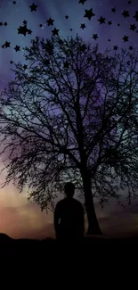 Silhouette of a tree against a starry, purple night sky with gradient hues.